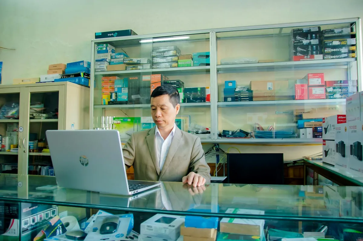 Store owner reviewing SEO audit report on laptop with Shopify admin open