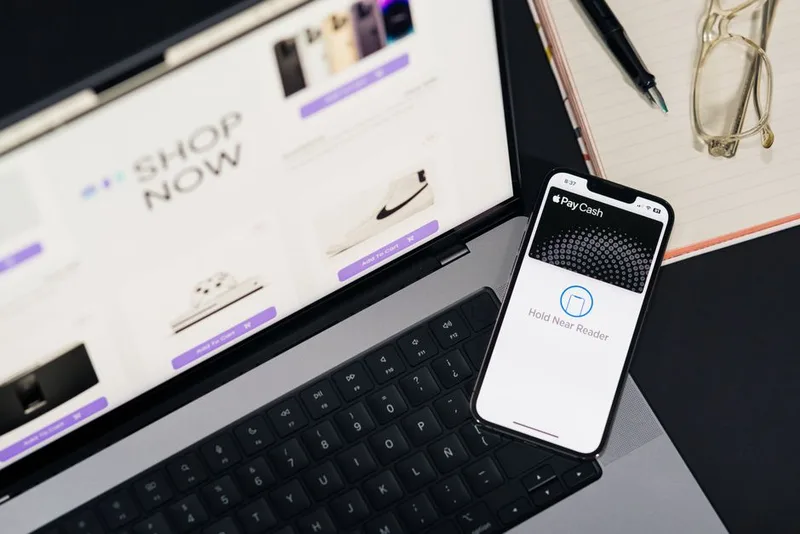 Laptop showing an online store next to a smartphone with a mobile payment screen