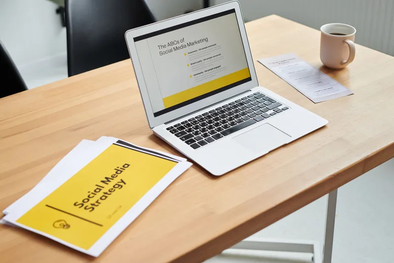 digital marketing strategy planning laptop and documents in office setting