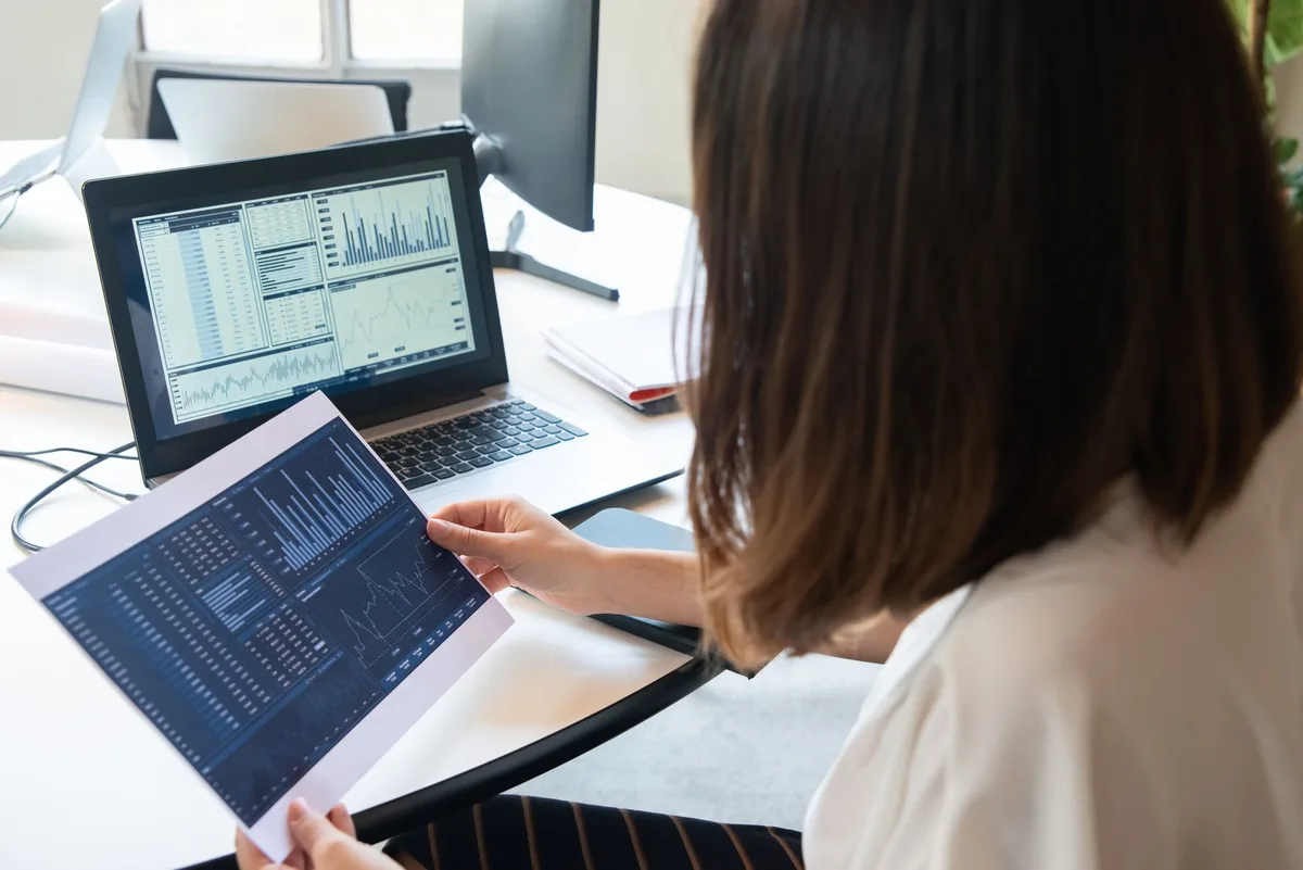 A Shopify store owner reviewing email campaign results on a laptop
